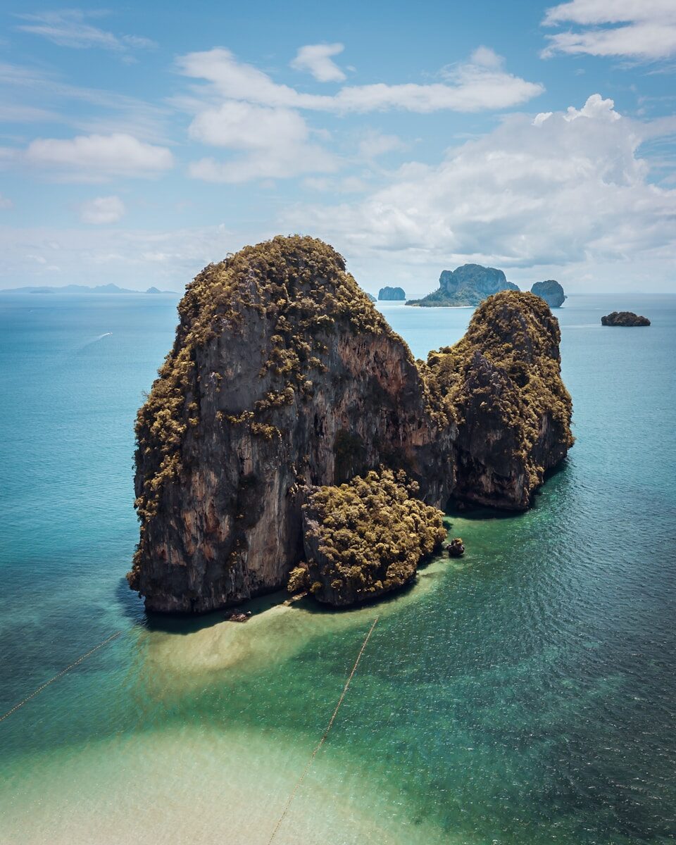 a couple of large rocks sitting in the middle of a body of water