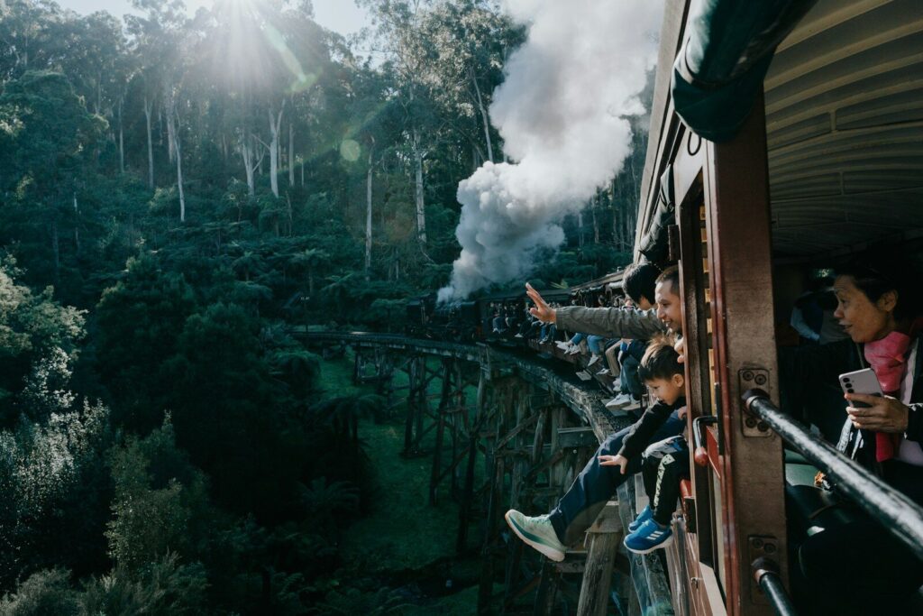 A group of people riding on the side of a train