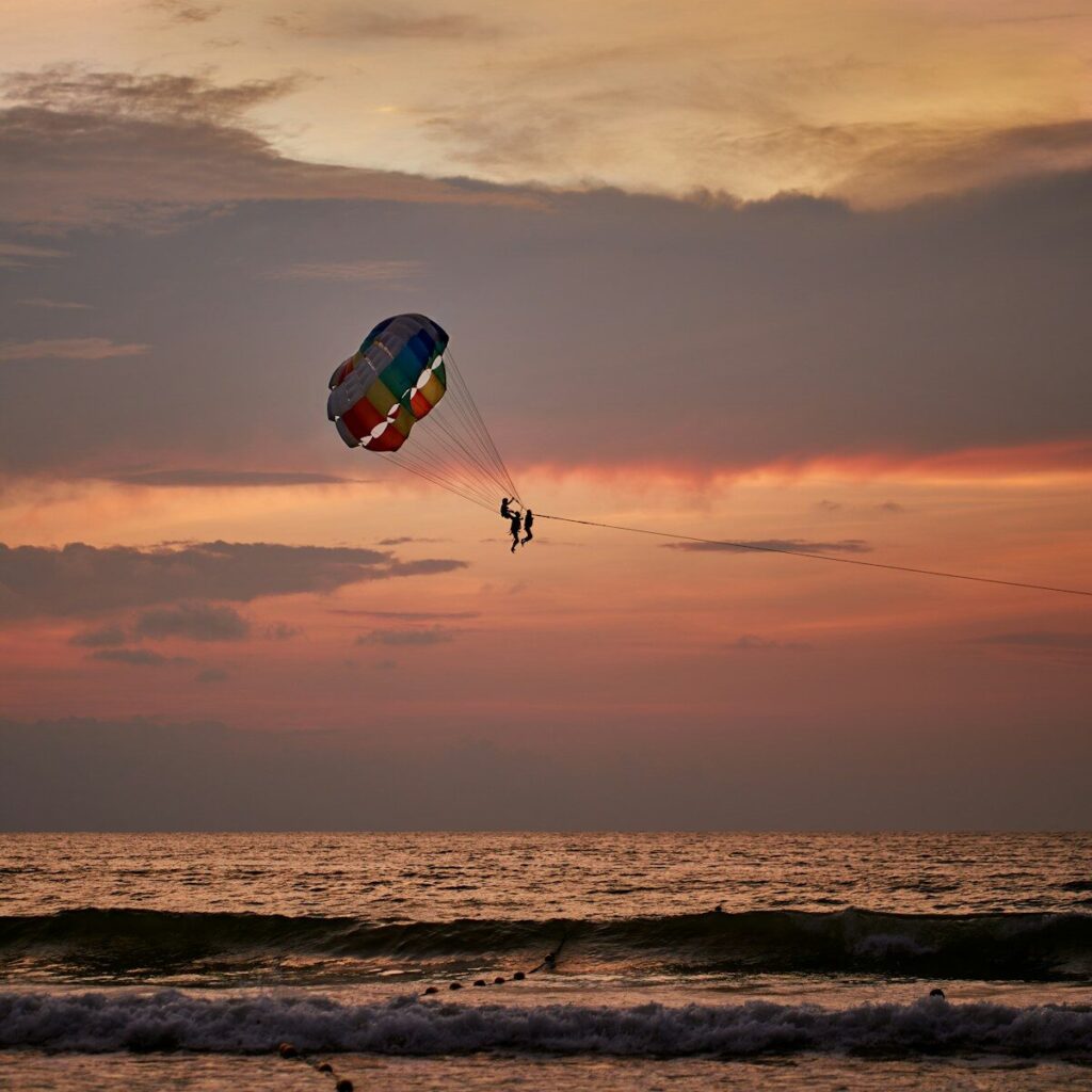 a person is parasailing in the ocean at sunset